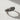 Close-up of the Gothic Claddagh Ring with skeleton hands, showing the detailed craftsmanship and shadow on a white surface.
