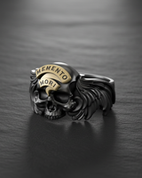 Angled view of the Silver Memento Mori Ring highlighting the oxidized finish and the intricate feather details on the wings.