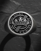 Top down close up of silver Templar ring displaying crown and cross motif with detailed engraving and text inscription