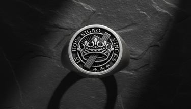 Top down close up of silver Templar ring displaying crown and cross motif with detailed engraving and text inscription
