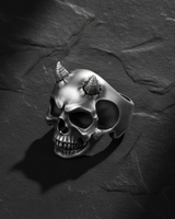 Top down perspective of demon skull ring highlighting cracked forehead detail around horns and sterling silver shine
