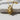 Gold-plated version of the wolf and knife pendant, showcasing the polished finish and sharp details on the dagger.