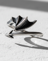 Close up of dragon wing texture and pointed tail on handcrafted sterling silver wrap ring