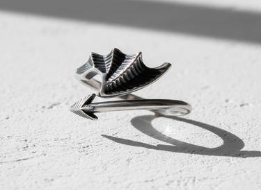 Close up of dragon wing texture and pointed tail on handcrafted sterling silver wrap ring