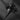 Top-down shot of the gothic Silver Skull Cross Pendant, with dramatic lighting creating deep shadows on a dark stone.