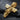 Angled shot of the gold-plated version of the Virgin Mary cross pendant, highlighting the deep grooves and lustrous finish.