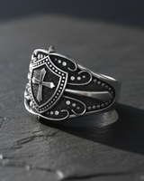 Side angle of sterling silver ring featuring intricate filigree patterns and shield design
