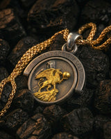 Front detail of the Silver Resurgent Knight Pendant with a gold-plated griffin holding a sphere, set on a dark silver coin.