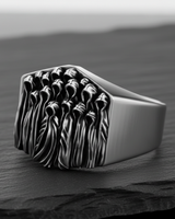 Close-up of the handcrafted Silver Ghost Ring detailing the oxidized finish inside the hollow hoods of the figures.