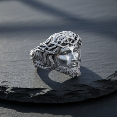 Polished 925 sterling silver Jesus ring showcasing the detailed face of Christ and the Crown of Thorns, styled on a dark slate surface.