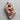 Angled view of rose gold Viking warrior amulet showing intricate armor details and rune carvings