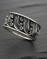 Side view of handcrafted silver wave ring showing the continuous relief pattern and oxidized finish depth