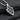 Back view of silver sword shield pendant showing smooth finish and polished surface