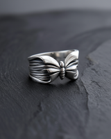 Angled view of handcrafted silver butterfly ring displaying band thickness and craftsmanship