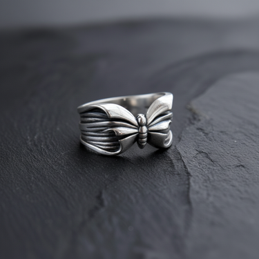 Angled view of handcrafted silver butterfly ring displaying band thickness and craftsmanship