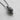 Three-quarter angle view of the Day of the Dead inspired skull pendant, showing the depth of the floral metalwork on the side.
