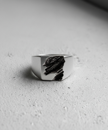 Front view of 925 sterling silver rift ring showing deep geological slate texture on signet face
