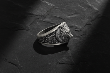 Side profile of sterling silver wolf head ring displaying high-relief carving and smooth interior band for comfort
