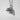 Pumpkin Leaf Pendant, polished silver, angled view against a white wall