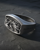 High angle view of handcrafted 925 silver signet ring with religious Sistine Chapel design on dark surface