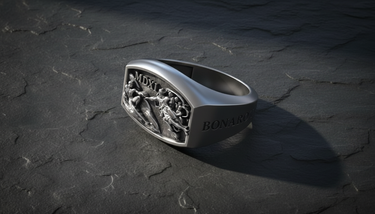 High angle view of handcrafted 925 silver signet ring with religious Sistine Chapel design on dark surface