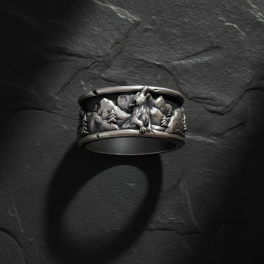Close-up of wolf howling at the moon relief design on oxidized sterling silver nature themed ring band