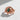 Rose gold vermeil dragon ring with intricate scale texture and emerald center stone