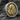 Handcrafted two-tone silver and gold Virgin Mary ring displayed on a textured stone background