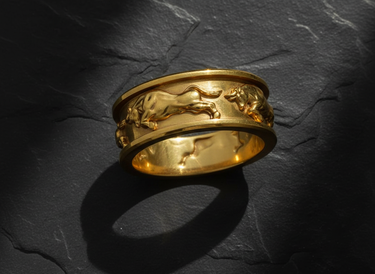 14K gold vermeil over silver bull ring featuring continuous charging taurus design on slate background