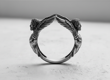 Side profile of gothic style silver angel ring showing oxidized finish and artistic metalwork