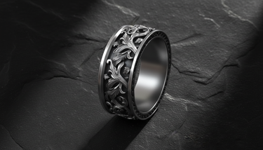 Close-up of Silver Rococo Band Ring showing raised ornamental borders and detailed botanical carving