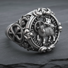 Silver Lamb of God ring showing the Agnus Dei and 'Ecce Agnus Dei' Latin inscription, resting on a dark slate surface.
