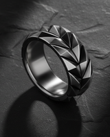 Close-up of handcrafted sterling silver ring showing sharp architectural details and oxidized depth