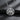Close-up of handcrafted brotherhood symbol necklace displaying triangle motif and sword design