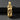 Gold-plated bullet skull pendant with a red gemstone eye, featuring a skull design breaking through the casing for a biker look.