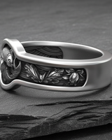 Side profile of sterling silver Japanese ornament ring displaying oxidized floral motifs and polished band thickness
