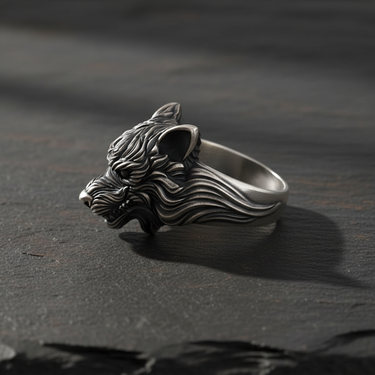 Profile view of sterling silver wolf ring highlighting intricate carving and ear details on slate surface