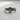Front view of silver true love waits ring featuring wrap around heart design and center stone on textured background