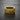 Gold vermeil silver iron cross ring with floral scrollwork engravings on black slate background