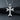 Close-up of oxidized sterling silver cross pendant showing detailed relief patterns and craftsmanship