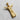 Angled flat lay of handcrafted silver Christ pendant highlighting the bail loop and intricate garment texture