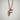 Bird Letter F Pendant, rose gold plated silver, front view on white wall