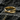 Minimalist Scandinavian 14K gold vermeil Mobius ring displayed elegantly on a dark textured rock surface.