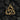 Close-up of gold vermeil Celtic triquetra pendant resting on dark charcoal highlighting detailed artisan craftsmanship