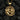 Close-up of the intricately carved twin horses pendant in gold vermeil resting against dark textured coal background