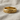 Detailed Celtic knot ring crafted with interwoven braided pattern resting softly on textured linen fabric.