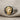 Angled close-up of the handcrafted Greek goddess ring resting on fabric, displaying the greek key band details.