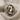 Close-up of luxury knight chess ring resting on textured fabric revealing intricate scrollwork and oxidized silver finish