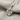 Leaf Twig Pendant, polished silver, angled close-up view on fabric