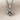 Heart clover pendant, oxidized silver, front view on linen texture